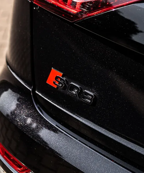 Zbliżenie na tylny zderzak samochodu wykończony w czerni.